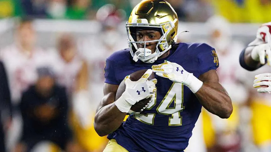 Notre Dame running back Jadarian Price runs with the ball on his way to score a touchdown against USC.