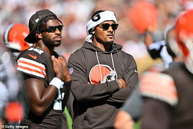 Quarterbacks Shedeur Sanders and Deshaun Watson watch from the sidelines during the fourth quarter against the Cincinnati Bengals at Huntington Bank Field on September 7
