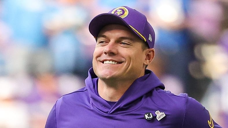 Kevin O’Connell runs onto the field before a Vikings game against the Detroit Lions.