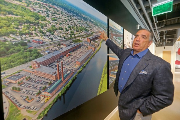 Sal Lupoli's Riverwalk complex in a mural inside his Lawrence office. (Stuart Cahill/Boston Herald)