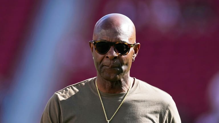 Former San Francisco 49ers player Jerry Rice walks on the...