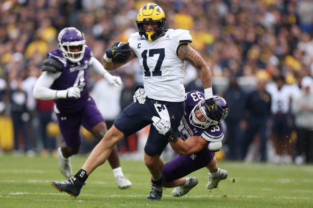 Marlin Klein #17 of the Michigan Wolverines is tackled by Braydon Brus #33 of the Northwestern Wildcats during the first half at Wrigley Field on November 15, 2025 in Chicago, Illinois. (Photo by Michael Reaves/Getty Images)