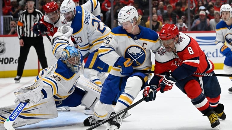 Washington Capitals left wing Alex Ovechkin (8) fight for a...