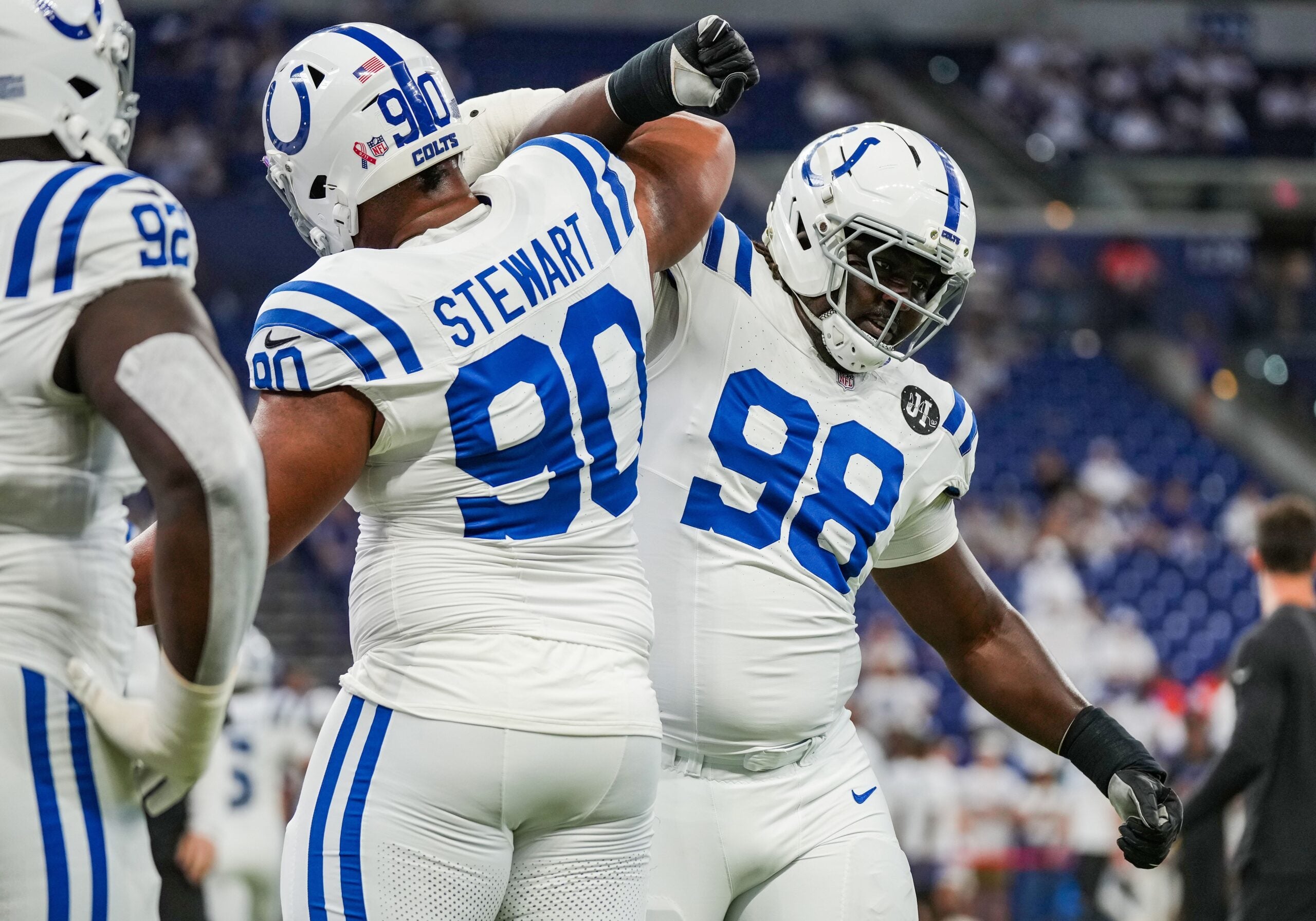 Indianapolis Colts defensive tackle Grover Stewart (90) locks arms with Indianapolis Colts defensive tackle Eric Johnson II (98) on Sunday, Sept. 14, 2025, ahead of the game against the Denver Broncos at Lucas Oil Stadium in Indianapolis.