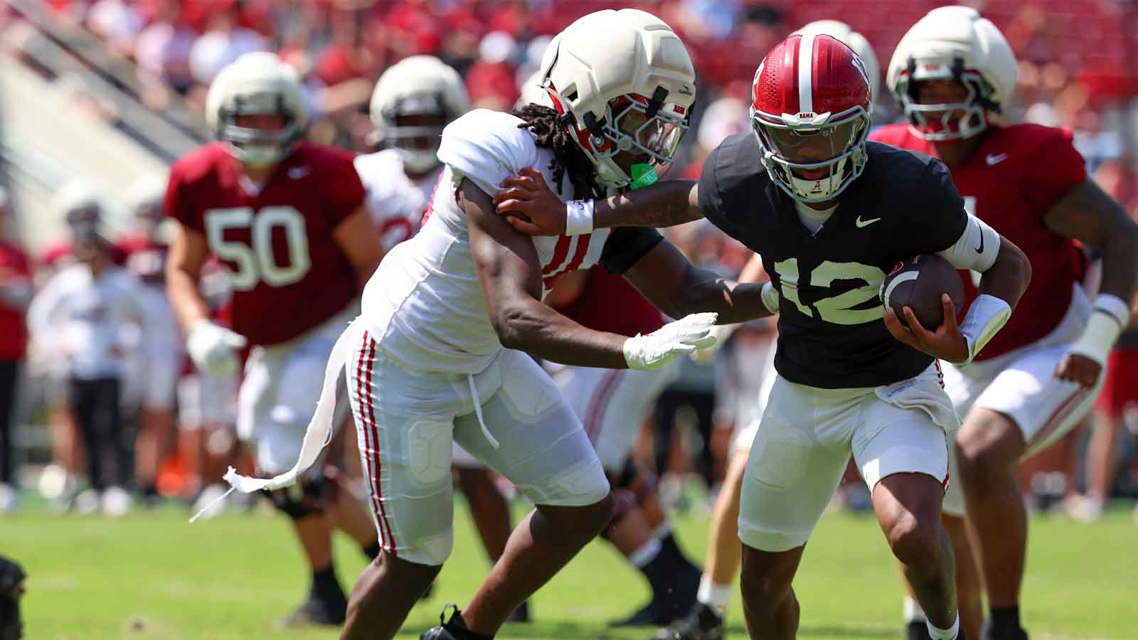 Alabama Crimson Tide quarterback Austin Mack (10) pursues quarterback Keelon Russell (12) during the Alabama A-Day spring football scrimmage game at Saban Field at Bryant-Denny Stadium.