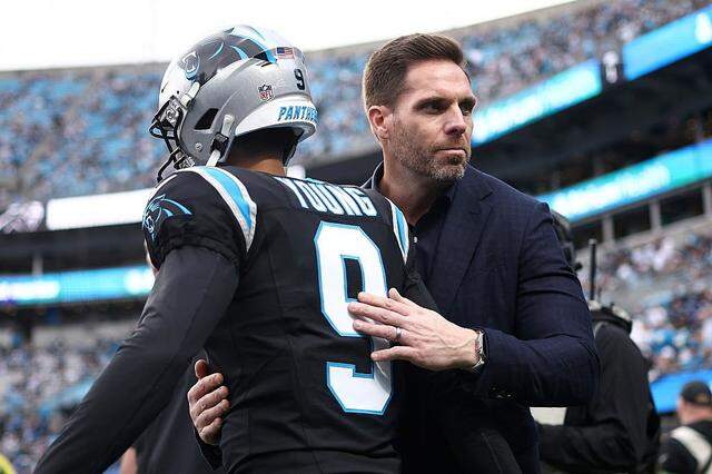 Dan Morgan, president of football operations and general manager for the Carolina Panthers, embraces Bryce Young prior to the NFC Wild Card Playoff game against the Los Angeles Rams at Bank of America Stadium on January 10, 2026 in Charlotte, North Carolina. (Photo by Jared C. Tilton/Getty Images)