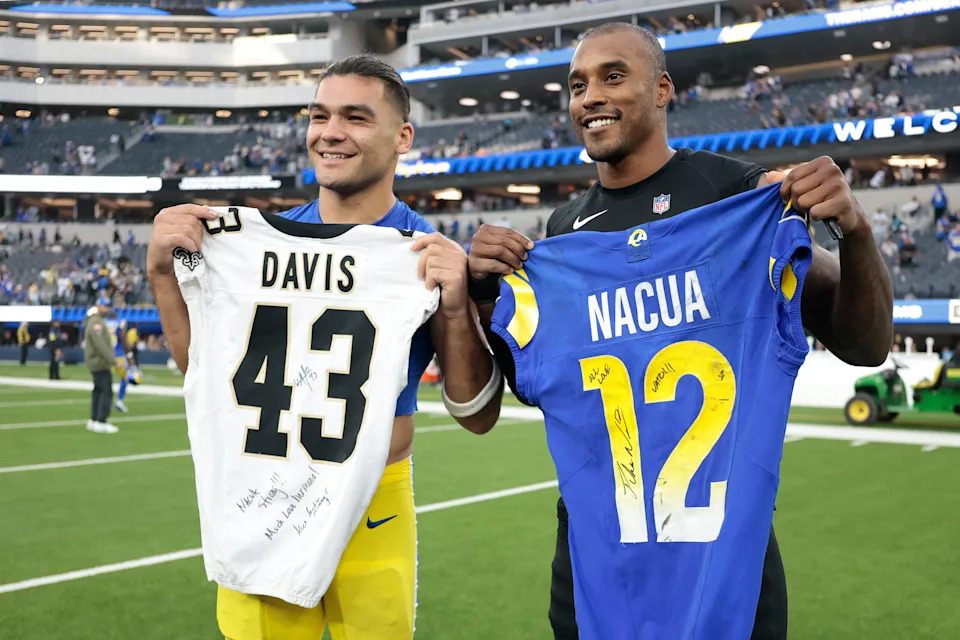 INGLEWOOD, CALIFORNIA - NOVEMBER 02: Puka Nacua #12 of the Los Angeles Rams and Michael Davis #43 of the New Orleans Saints pose for a photo after trading jersey following the game at SoFi Stadium on November 02, 2025 in Inglewood, California. (Photo by Ronald Martinez/Getty Images)