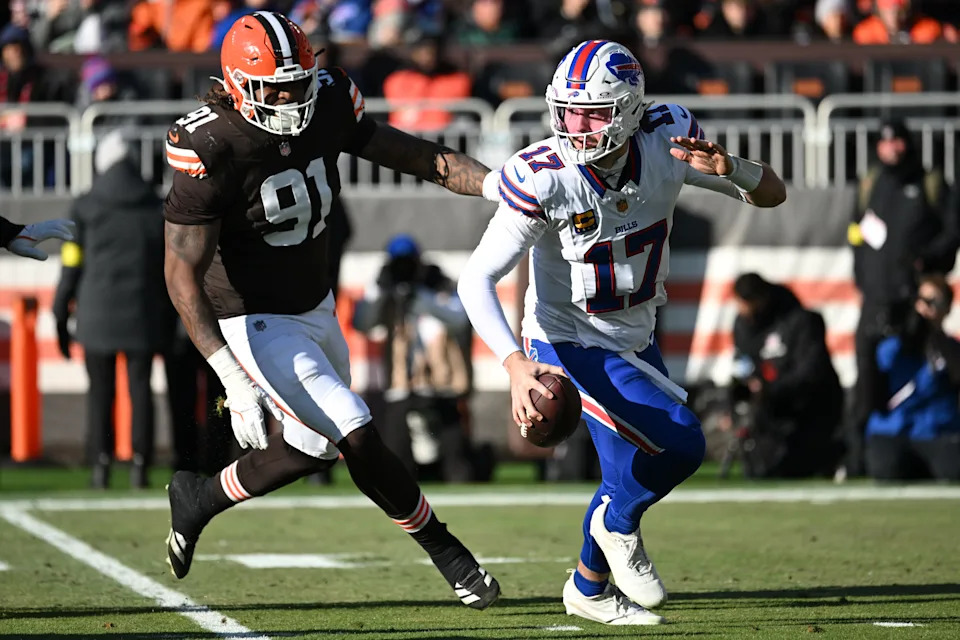 Dec 21, 2025; Cleveland, Ohio, USA; Buffalo Bills quarterback Josh Allen (17) is pressured by Cleveland Browns defensive end Alex Wright (91) during the first half at Huntington Bank Field. Mandatory Credit: Ken Blaze-Imagn Images