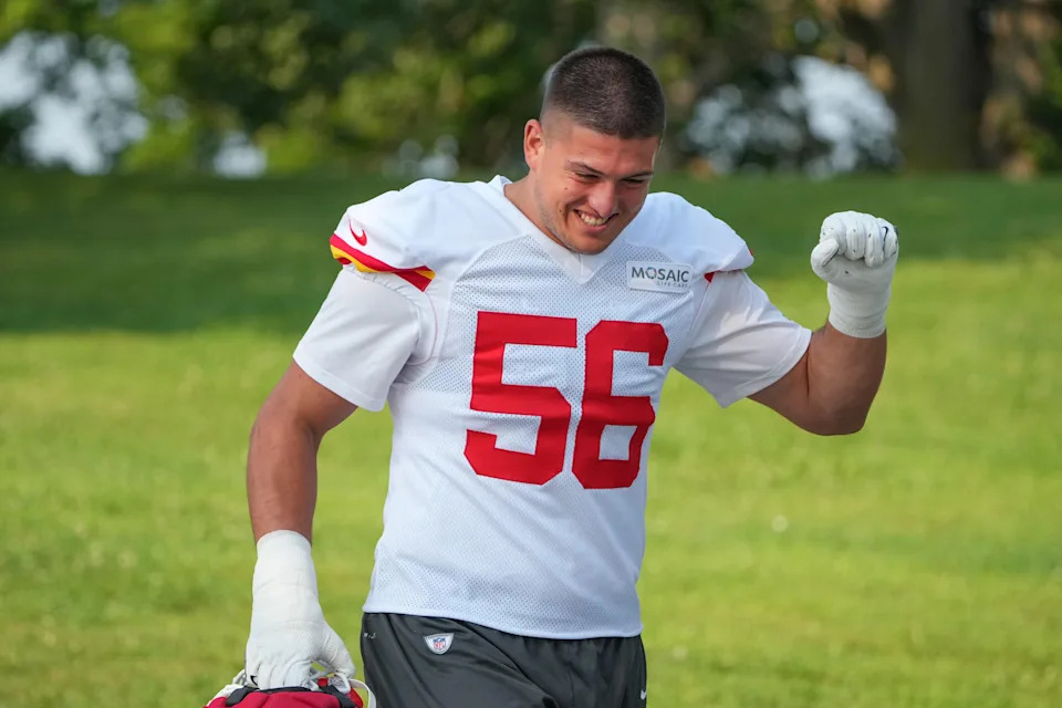 Jul 22, 2024; St. Joseph, MO, USA; Kansas City Chiefs defensive end George Karlaftis (56) celebrates toward fans while walking down the hill from the locker room to the fields prior to training camp at Missouri Western State University. Mandatory Credit: Denny Medley-USA TODAY Sports