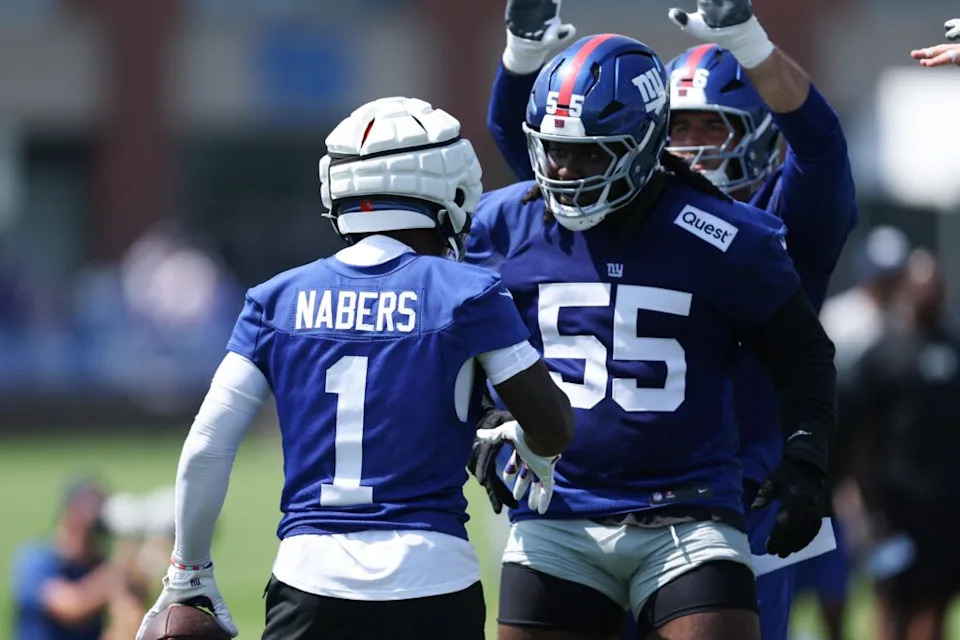 New York Giants wide receiver Malik Nabers celebrates with offensive tackle James Hudson III during training camp at Quest Diagnostics Training Center.