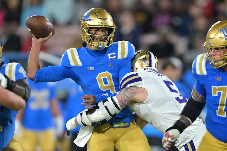 Nov 22, 2025; Pasadena, California, USA; UCLA Bruins quarterback Nico Iamaleava (9) is pressured by Washington Huskies linebacker Zach Durfee (5) during the first half at the Rose Bowl. Mandatory Credit: Jayne Kamin-Oncea-Imagn Images