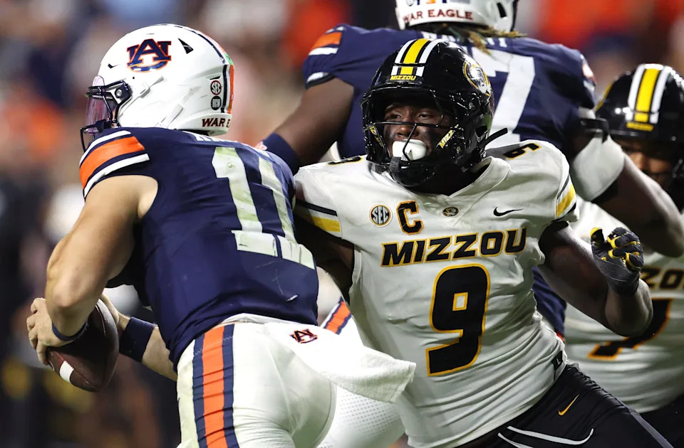 Oct 18, 2025; Auburn, Alabama, USA; Missouri Tigers defensive end Zion Young (9) moves in to tackle Auburn Tigers quarterback Jackson Arnold (11) during the fourth quarter at Jordan-Hare Stadium. Mandatory Credit: John Reed-Imagn Images