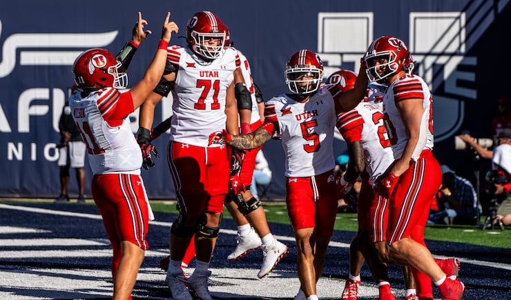 Utah offensive tackle Caleb Lomu celebrates a touchdown during game against Utah State at Maverik Stadium in Logan, Utah, on Saturday, September 14, 2024.