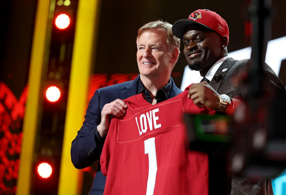 PITTSBURGH, PENNSYLVANIA - APRIL 23: Jeremiyah Love (R) of Notre Dame poses with NFL Commissioner Roger Goodell (L) after being selected third overall pick by the Arizona Cardinals during Round One of the 2026 NFL Draft at Acrisure Stadium on April 23, 2026 in Pittsburgh, Pennsylvania. (Photo by Emilee Chinn/Getty Images)