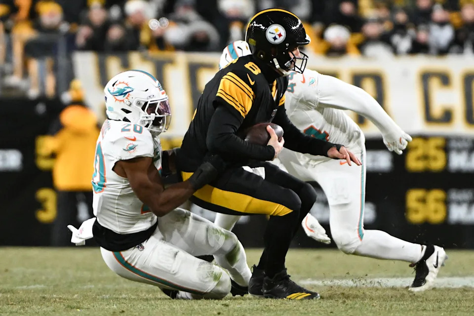 Dec 15, 2025; Pittsburgh, Pennsylvania, USA; Pittsburgh Steelers quarterback Aaron Rodgers (8) is sacked by Miami Dolphins linebacker Jordyn Brooks (20) in the first quarter at Acrisure Stadium. Mandatory Credit: Barry Reeger-Imagn Images