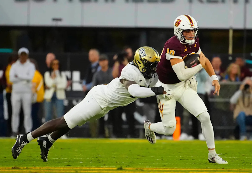 UCF defensive end Malachi Lawrence (51) tackles ASU quarterback Sam Leavitt (10) as he scrambles during a game at Mountain America Stadium in Tempe on Nov. 9, 2024.