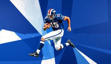 A fragmented, geometric painting depicting a football player in motion, with sharp planes of navy blue, royal blue, and white overlapping to create a sense of dynamism and movement.