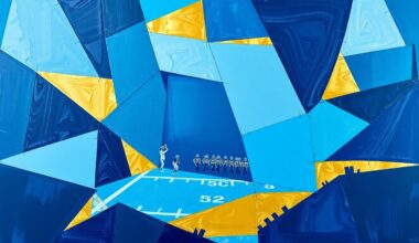 A cubist, geometric painting depicting fragmented football players and draft prospects, rendered in navy blue, powder blue, and gold tones to capture the strategic evaluation process of an NFL team.