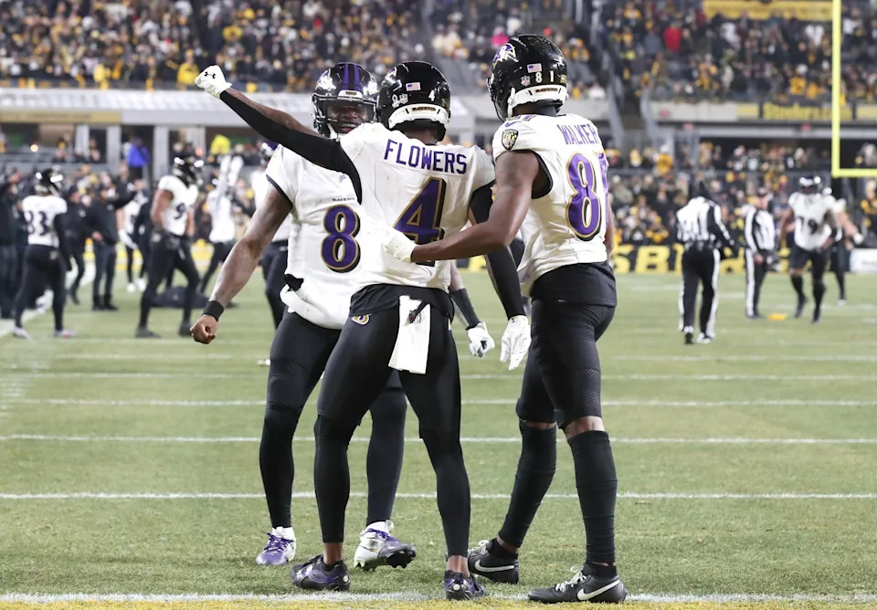 Jan 4, 2026; Pittsburgh, Pennsylvania, USA; Baltimore Ravens wide receiver Zay Flowers (4) reacts with quarterback Lamar Jackson (8) after scoring a touchdown against the Pittsburgh Steelers during the second half at Acrisure Stadium. Mandatory Credit: Charles LeClaire-Imagn Images