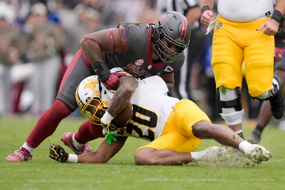 Oklahoma Sooners defensive lineman Gracen Halton (56) brings down Missouri Tigers running back Jamal Roberts (20) during a college football game between the University of Oklahoma Sooners (OU) and the Missouri Tigers at Gaylord Family Ã Oklahoma Memorial Stadium in Norman, Okla., on Saturday, Nov. 22, 2025. Oklahoma won 17-6.