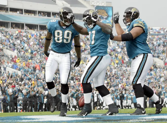 Nov 5, 2006; Jacksonville, FL, USA: Jacksonville Jaguars tight end (87) George Wrighster celebrates a touchdown with teammates (89) Marcedes Lewis and (65) Chris Naeole after scoring during the 1st quarter at against the Tennessee Titans at Alltel Stadium in Jacksonville, FL. Mandatory Credit: Jason Parkhurst-USA TODAY Sports Copyright © 2006 Jason Parkhurst
