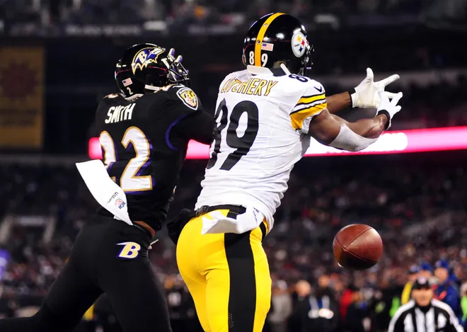 Nov 28, 2013; Baltimore, MD, USA; Baltimore Ravens cornerback Jimmy Smith (22) knocks the ball away from Pittsburgh Steelers wide receiver Jerricho Cotchery (89) during a NFL football game on Thanksgiving at M&T Bank Stadium. Mandatory Credit: Evan Habeeb-USA TODAY Sports