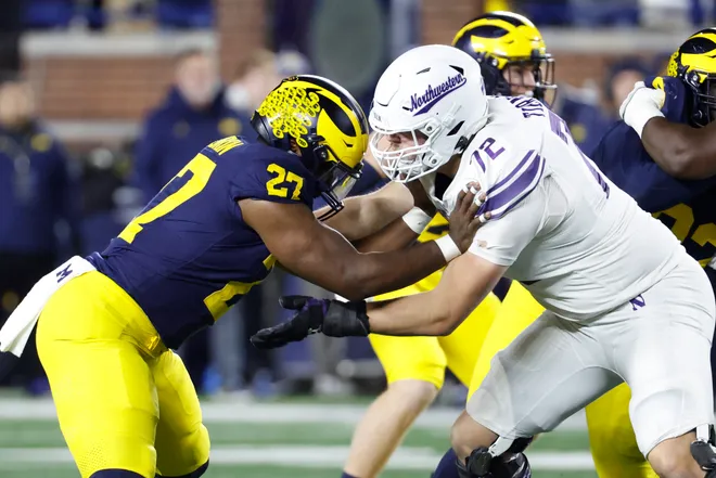 Nov 23, 2024; Ann Arbor, Michigan, USA; Northwestern Wildcats offensive lineman Caleb Tiernan (72) blocks Michigan Wolverines defensive end Tyler McLaurin (27) in the second half at Michigan Stadium. Mandatory Credit: Rick Osentoski-Imagn Images