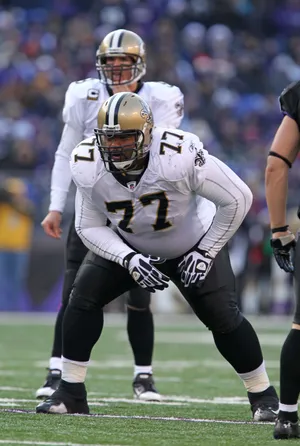 December 19, 2010; Baltimore, MD, USA; New Orleans Saints guard Carl Nicks (77) blocks for quarterback Drew Brees (background) against the Baltimore Ravens at M&T Bank Stadium. The Ravens beat the Saints 30-24. Mandatory Credit: Mitch Stringer-USA TODAY Sports