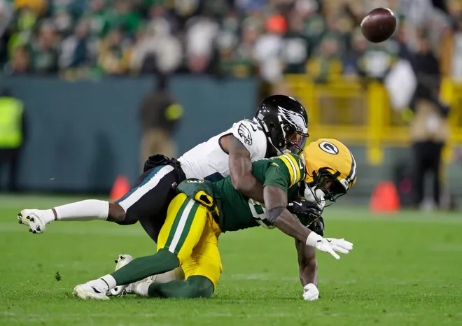 Philadelphia Eagles cornerback Quinyon Mitchell (27) breaks up a pass intended for Green Bay Packers wide receiver Romeo Doubs (87) in the fourth quarter during their football game Monday, November 10, 2025, at Lambeau Field in Green Bay, Wisconsin.