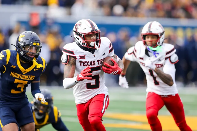 Nov 29, 2025; Morgantown, West Virginia, USA; Texas Tech Red Raiders wide receiver Caleb Douglas (5) makes a catch and runs for extra yards during the second quarter against the West Virginia Mountaineers at Milan Puskar Stadium. Mandatory Credit: Ben Queen-Imagn Images