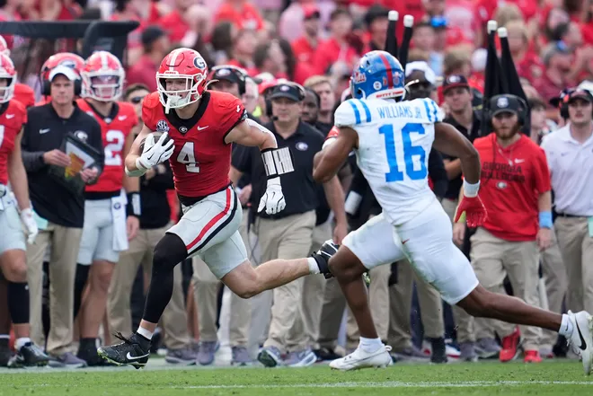 Oct 18, 2025; Athens, Georgia, USA; Georgia Bulldogs tight end Oscar Delp (4) runs the ball against Mississippi Rebels safety Wydett Williams Jr. (16) during the first half of the game at Sanford Stadium. Mandatory Credit: Brett Davis-Imagn Images