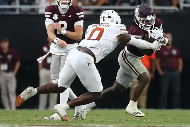 Oct 25, 2025; Starkville, Mississippi, USA; Mississippi State Bulldogs running back Davon Booth (6) runs the ball as Texas Longhorns linebacker Anthony Hill Jr. (0) makes the tackle during the third quarter at Davis Wade Stadium at Scott Field. Mandatory Credit: Petre Thomas-Imagn Images