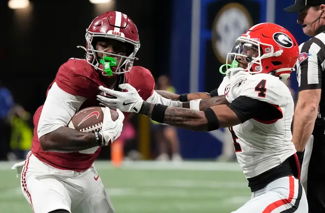 Dec 6, 2025; Atlanta, GA, USA; Alabama wide receiver Germie Bernard (5) uses a stiff arm to break a tackle by Georgia defensive back KJ Bolden (4) at Mercedes-Benz Stadium. Mandatory Credit: Gary Cosby Jr.-Tuscaloosa News