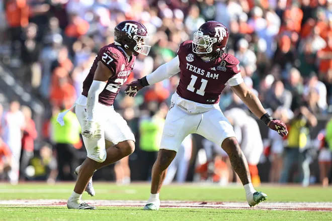 Dec 20, 2025; College Station, TX, USA; Texas A&M Aggies linebacker Daymion Sanford (27) reacts with defensive tackle Tyler Onyedim (11) after recovering a fumble against the Miami Hurricanes during the second half of the first round game of the CFP National Playoff at Kyle Field. Mandatory Credit: Maria Lysaker-Imagn Images
