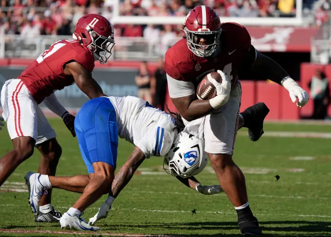 Nov 22, 2025; Tuscaloosa, Alabama, USA; Alabama offensive lineman Kadyn Proctor (74) catches a short pass and runs the ball during the game with Eastern Illinois at Saban Field at Bryant-Denny Stadium. Mandatory Credit: Gary Cosby Jr.-Imagn Images
