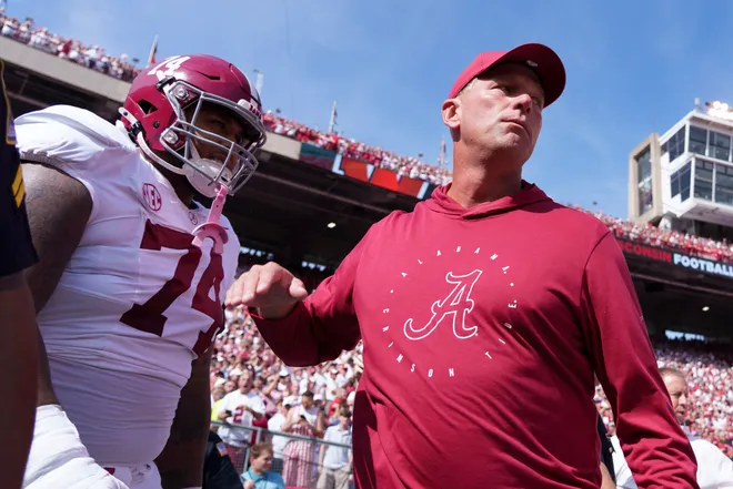 Sep 14, 2024; Madison, Wisconsin, USA; Alabama Crimson Tide head coach Kalen DeBoer greets offensive linenam Kadyn Proctor (74) prior to the game against the Wisconsin Badgers at Camp Randall Stadium. Mandatory Credit: Jeff Hanisch-Imagn Images