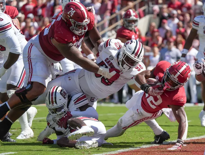 Oct 12, 2024; Tuscaloosa, Alabama, USA; Alabama Crimson Tide running back Justice Haynes (22) lunges across the goal line as Alabama Crimson Tide offensive lineman Kadyn Proctor (74) blocks on South Carolina Gamecocks defensive tackle Nick Barrett (93) at Bryant-Denny Stadium. Mandatory Credit: Gary Cosby Jr.-Imagn Images