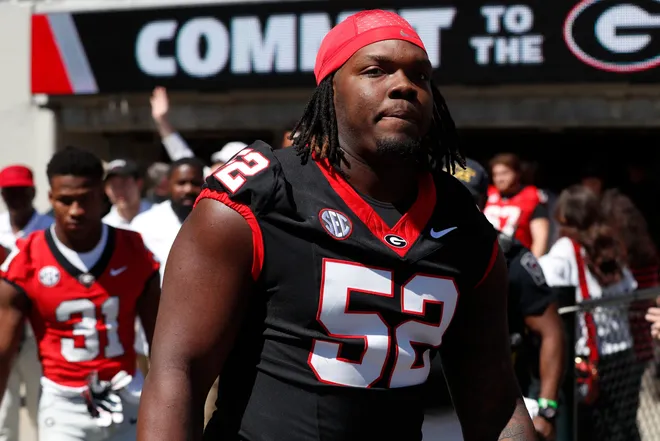 Georgia defensive lineman Christen Miller (52) arrives with the team before the start of the G-Day spring football game in Athens, Ga., on Saturday, April 13, 2024.