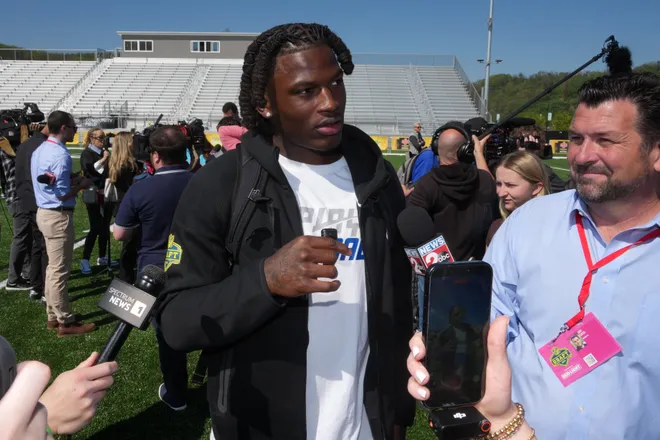 Apr 22, 2026; Pittsburgh, PA, USA; Ohio State Buckeyes linebacker Arvell Reese (left) is interviewed by WKRN News 2 television sports anchor Cory Curtis during the NFL Draft prospects clinic at Hazelwood Green Park. Mandatory Credit: Kirby Lee-Imagn Images