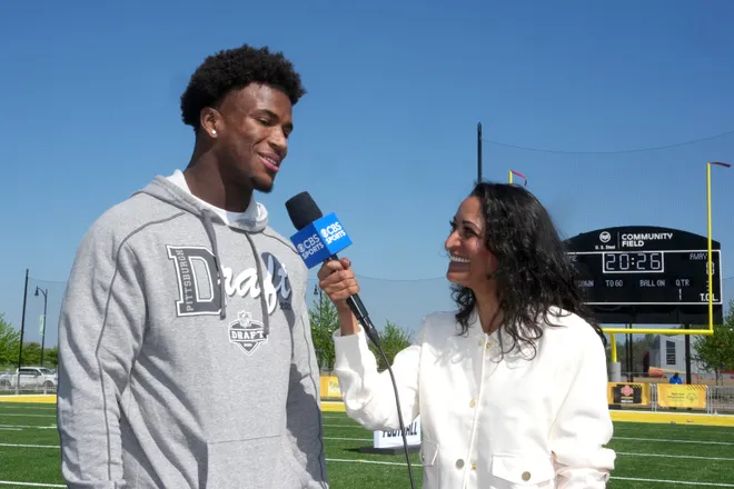 Apr 22, 2026; Pittsburgh, PA, USA; Ohio State Buckeyes defensive back Caleb Downs (left) is interviewed by CBS Sports female reporter Aditi Kinkhabwala during the NFL Draft prospects clinic at Hazelwood Green Park. Mandatory Credit: Kirby Lee-Imagn Images
