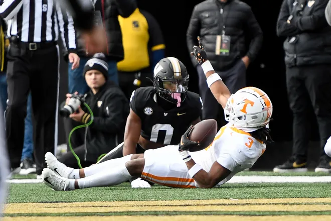 Nov 30, 2024; Nashville, Tennessee, USA; Tennessee Volunteers defensive back Jermod McCoy (3) intercepts the pass thrown to Vanderbilt Commodores wide receiver Junior Sherrill (0) during the first half at FirstBank Stadium. Mandatory Credit: Steve Roberts-Imagn Images
