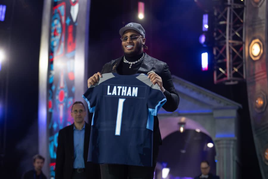 Alabama Offensive Tackle JC Latham holds up a jersey after being taken 7th overall by the Tennessee Titans during Day 1 of the NFL Draft on April 25, 2024 at Campus Martius Park and Hart Plaza in Detroit, MI. (Photo by John Smolek/Icon Sportswire via Getty Images)