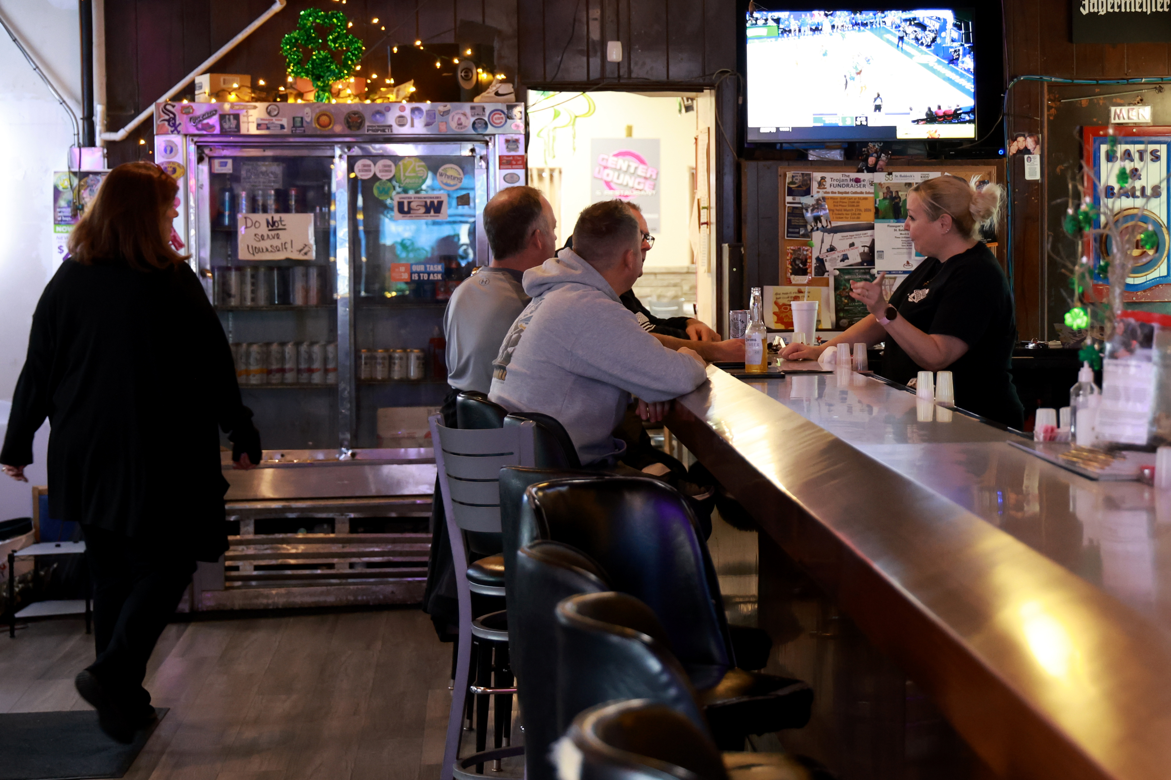 Bartender Chrissy Chovan serves up drinks and chats with patrons...