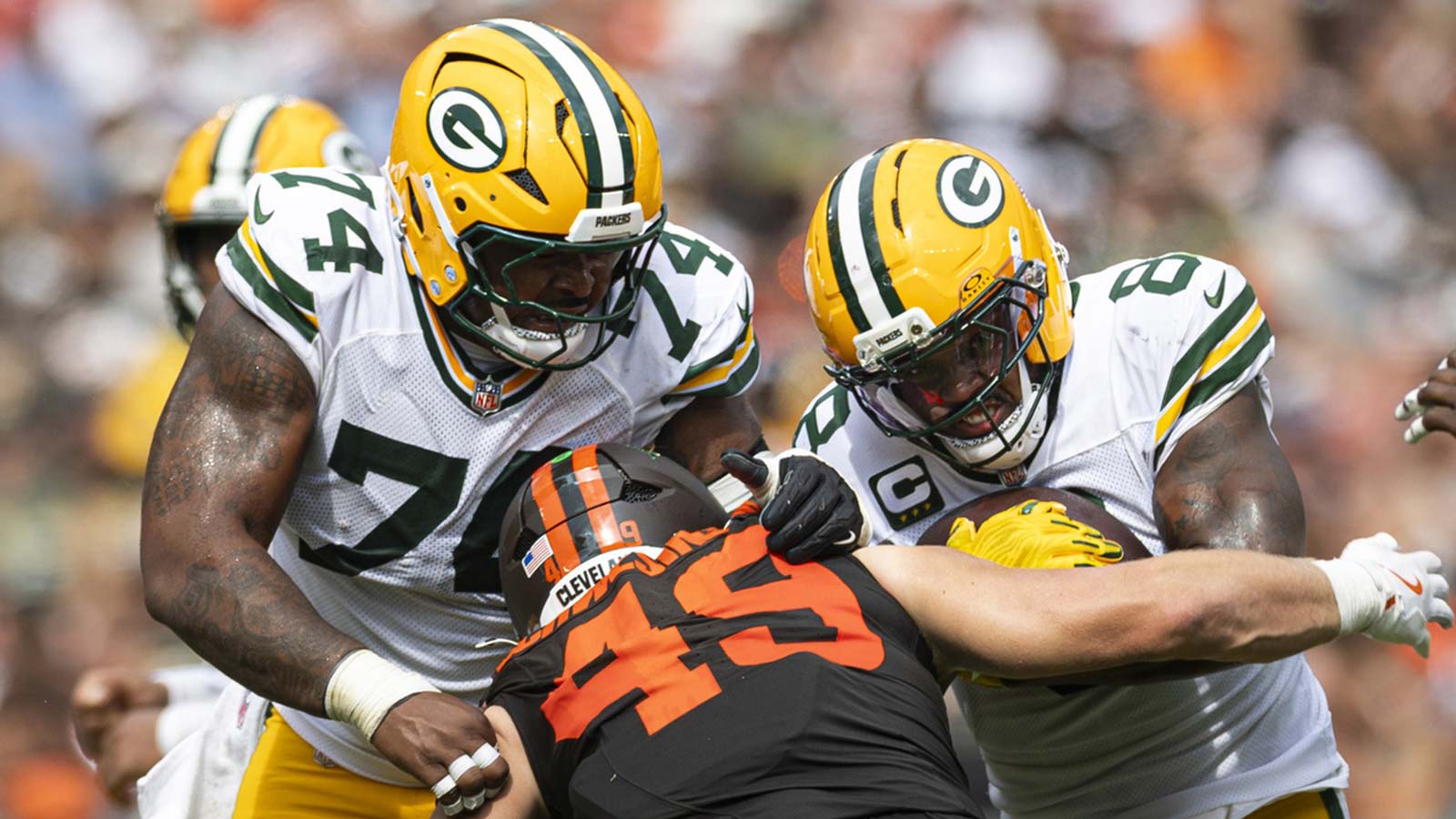Green Bay Packers running back Josh Jacobs (8) runs the ball as guard Elgton Jenkins (74) blocks Cleveland Browns linebacker Carson Schwesinger (49) during the third quarter at Huntington Bank Field.