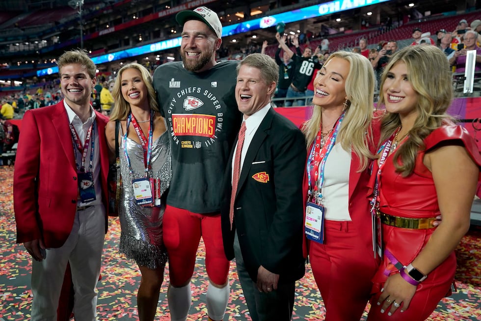 Kansas City Chiefs owner Clark Hunt, center right, poses with his family and tight end Travis...