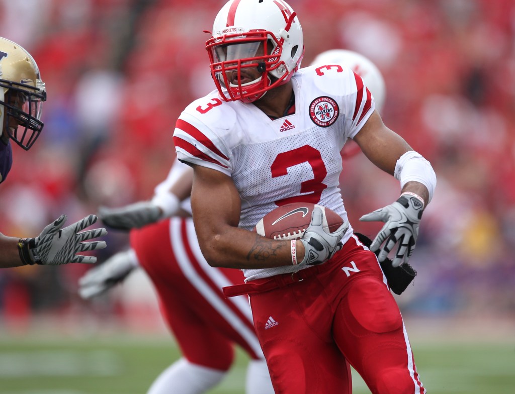 Nebraska Cornhuskers' Safety Rickey Thenarse in his uniform, holding an intercepted football.