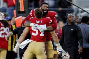 Trent Williams #71 of the San Francisco 49ers hugs Nick Bosa #97 of the San Francisco 49ers during the fourth quarter against the Miami Dolphins at Levi's Stadium on December 04, 2022 in Santa Clara, California.