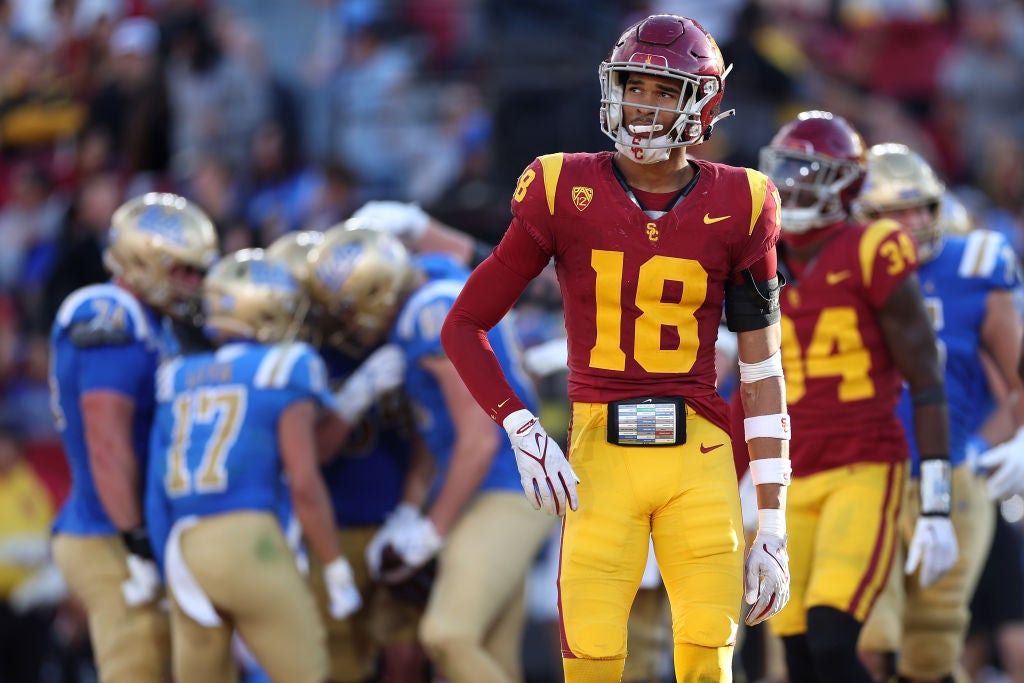 LOS ANGELES, CALIFORNIA - NOVEMBER 18: Eric Gentry #18 of the USC Trojans looks on as teamates congratulate Hudson Habermehl #81 of the UCLA Bruins after his passing touchdown during the second half of a game at United Airlines Field at the Los Angeles Memorial Coliseum on November 18, 2023 in Los Angeles, California. (Photo by Sean M. Haffey/Getty Images)