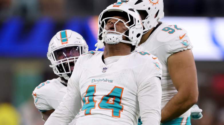 Chop Robinson of the Miami Dolphins reacts after sacking Matthew Stafford