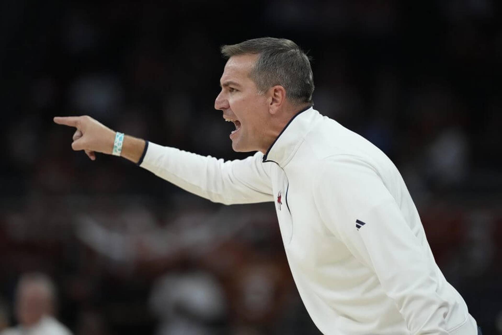 Aaron Roussell, yelling and pointing his finger, coaches Richmond in November 2025.